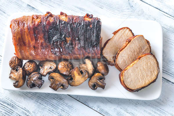 Pork loin wrapped in bacon with roasted mushrooms Stock photo © Alex9500