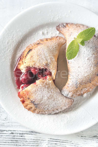 Cherry empanadas on the white plate Stock photo © Alex9500