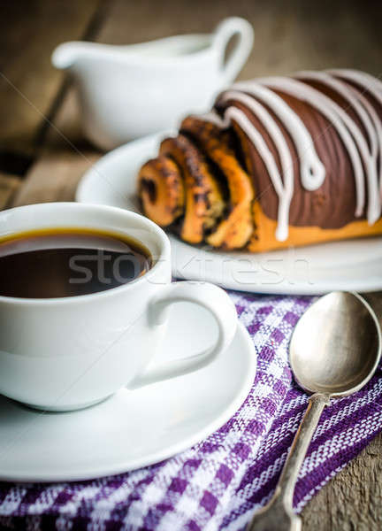 Cup of coffee and poppy bun glazed with ganache Stock photo © Alex9500