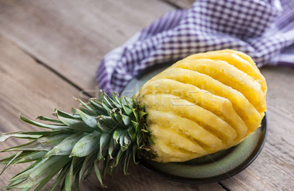 Pineapple on the plate on the wooden background Stock photo © Alex9500