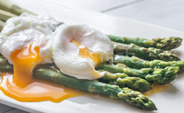 Steamed asparagus with poached eggs Stock photo © Alex9500