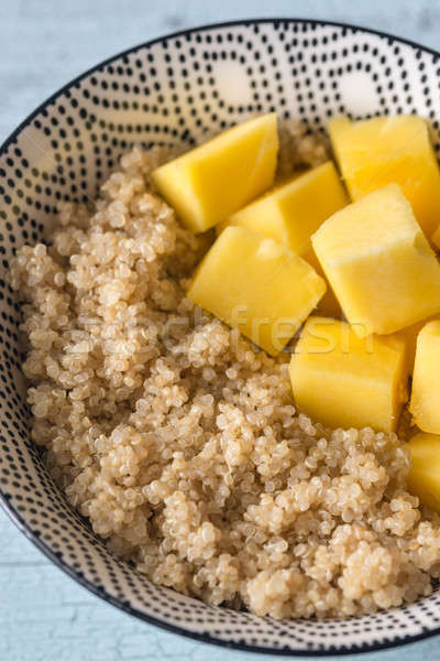 Portion of cooked quinoa with mango slices Stock photo © Alex9500