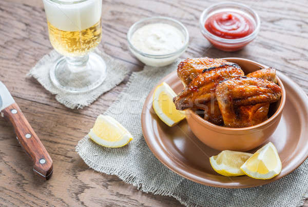Caramelized chicken wings with glass of beer Stock photo © Alex9500