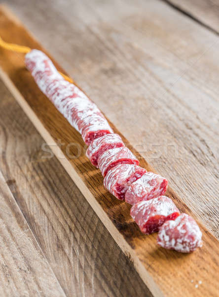 Cut spanish salami on the wooden board Stock photo © Alex9500
