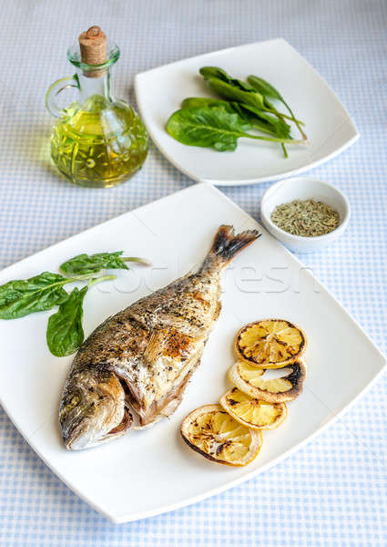 Grilled dorada fish with lemon and spinach Stock photo © Alex9500