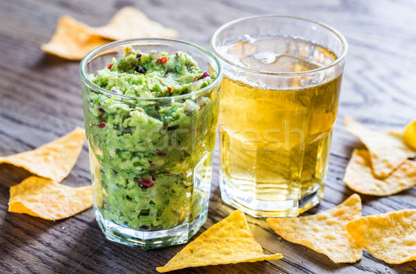 Guacamole with tortilla chips and glass of beer Stock photo © Alex9500