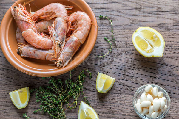 Raw shrimps with lemon wedges Stock photo © Alex9500