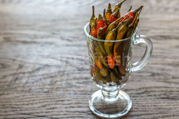 Stock photo: Marinated peppers in the glass