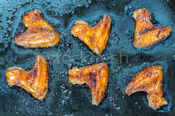 Caramelized chicken wings on the baking tray Stock photo © Alex9500