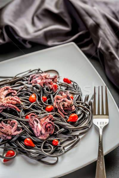 Pasta with black cuttlefish ink and small octopuses Stock photo © Alex9500
