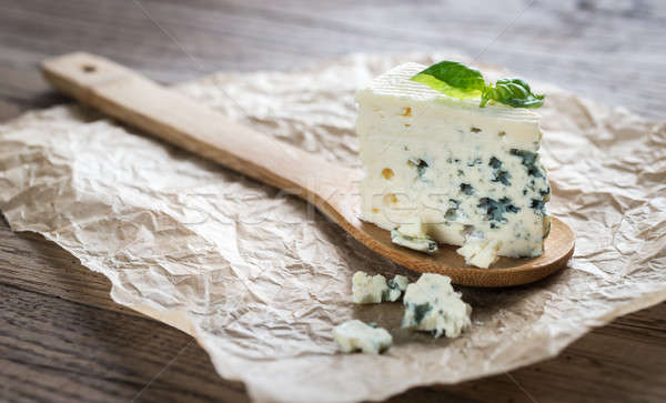 Piece of the blue cheese on the wooden spoon Stock photo © Alex9500