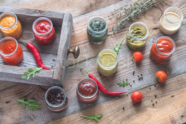 Assortment of sauces in the glass jars with ingredients Stock photo © Alex9500
