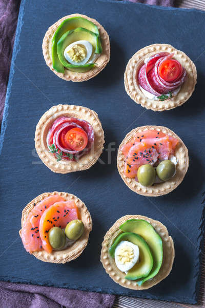 Tartlets with different fillings on the stone board Stock photo © Alex9500