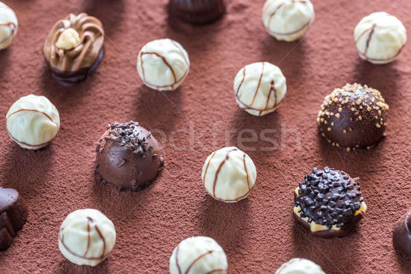 Chocolate candies on cocoa background Stock photo © Alex9500