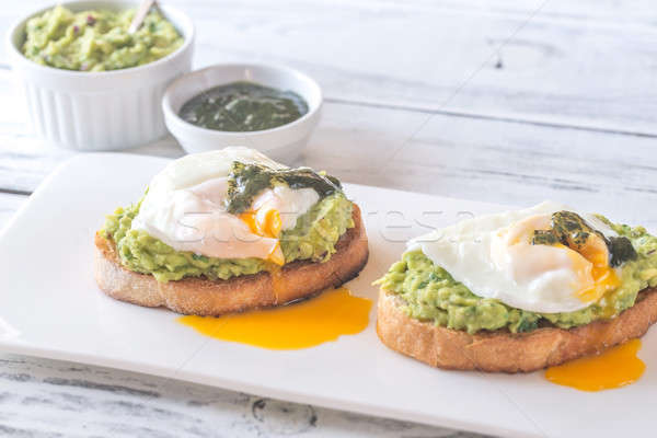 Sandwiches with guacamole and poached eggs Stock photo © Alex9500