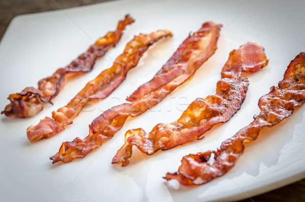 Fried bacon strips on the square plate Stock photo © Alex9500