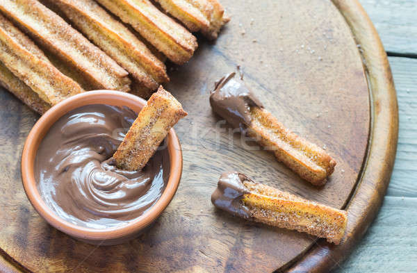 Churros - famous Spanish dessert with chocolate sauce Stock photo © Alex9500