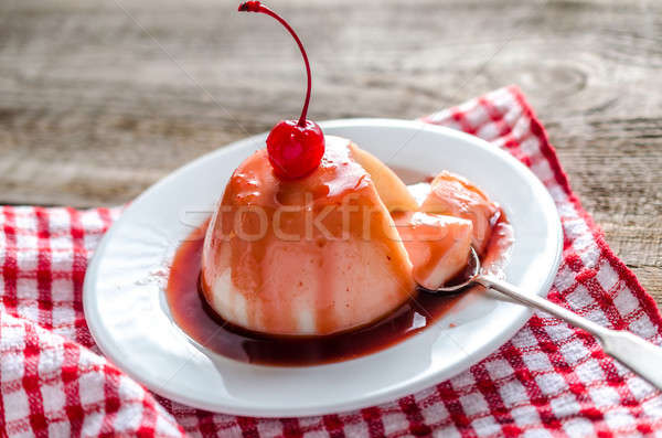 Panna cotta with berry sauce and maraschino cherry Stock photo © Alex9500