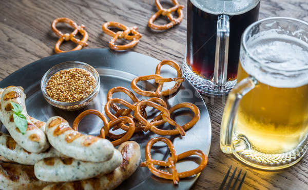 Grilled sausages with pretzels and mugs of beer Stock photo © Alex9500