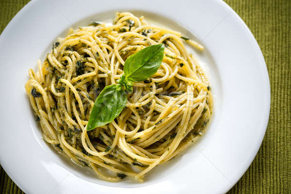 Portion of pasta with pesto sauce and basil leaf Stock photo © Alex9500