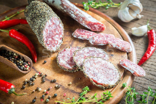 Slices of saucisson and fuet on the wooden board Stock photo © Alex9500