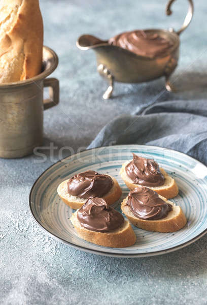 Slices of baguette with chocolate cream on the plate Stock photo © Alex9500