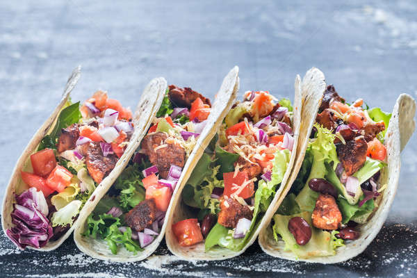 Four mexican tacos on a black background Stock photo © Alex9500