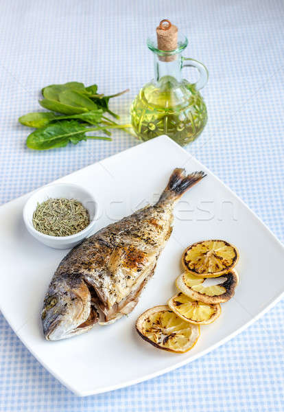 Grilled dorada fish with lemon and spinach Stock photo © Alex9500