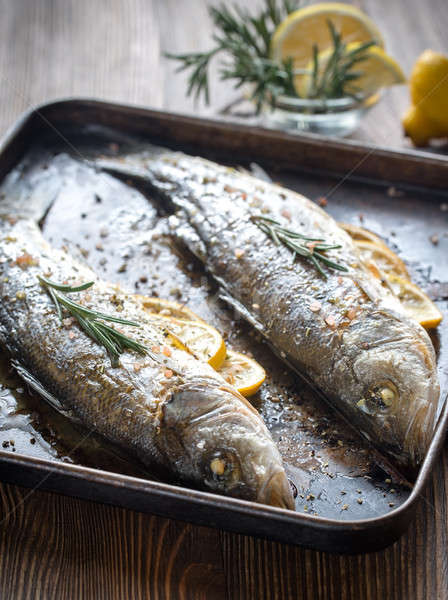 Baked sea bass with lemon and rosemary Stock photo © Alex9500