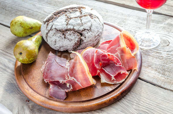 Slices of italian ham with glass of wine on the wooden board Stock photo © Alex9500