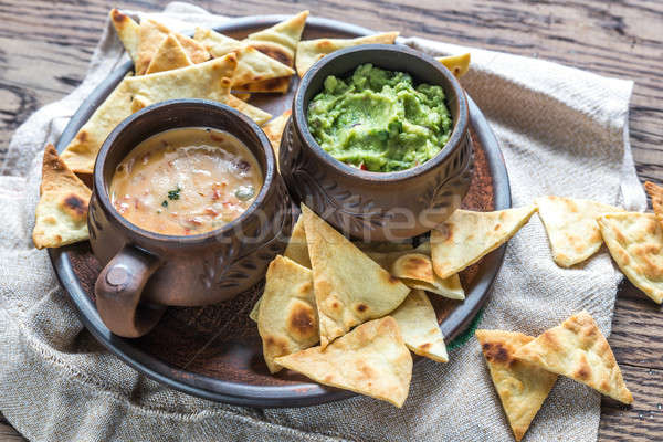 Bowls of guacamole and queso with tortilla chips Stock photo © Alex9500