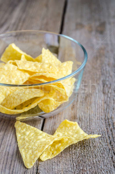 Heap of corn chips in the glass bowl on the wooden background Stock photo © Alex9500