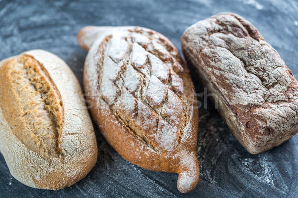 Whole grain breads on the dark wooden background Stock photo © Alex9500