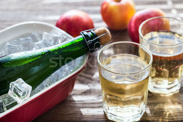 Bottle and two glasses of cider on the wooden background Stock photo © Alex9500