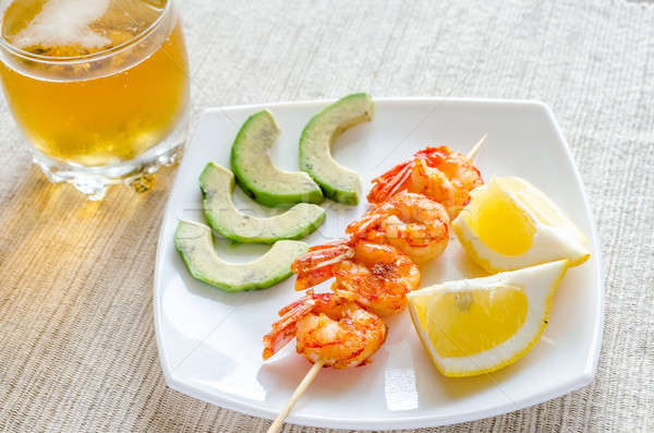 Shrimps skewers with avocado and lemon slices Stock photo © Alex9500