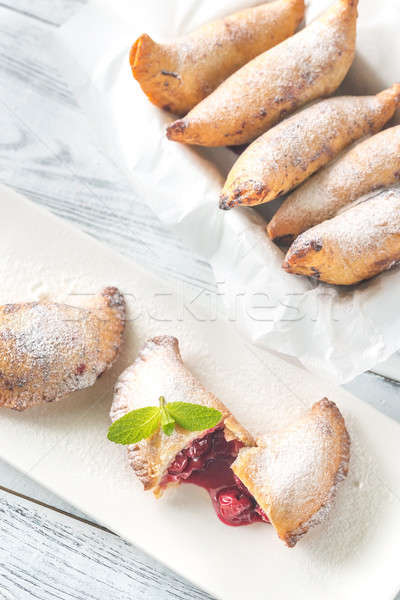 Cherry empanadas on the white plate Stock photo © Alex9500