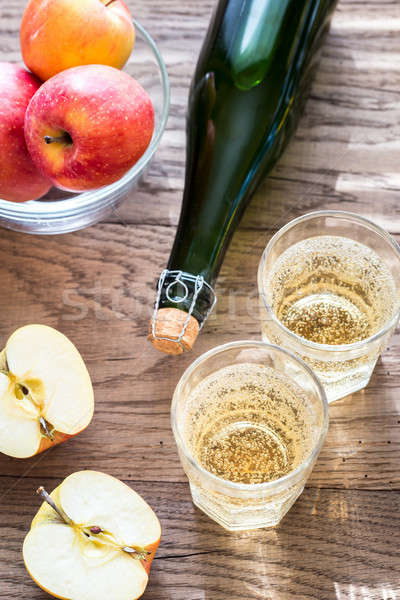 Bottle and two glasses of cider on the wooden background Stock photo © Alex9500