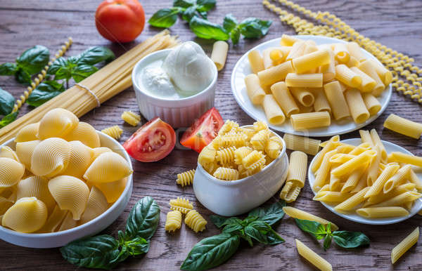 Various types of pasta on the wooden background Stock photo © Alex9500