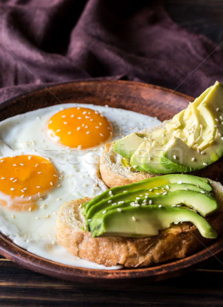 Fried eggs with toasts and avocado Stock photo © Alex9500