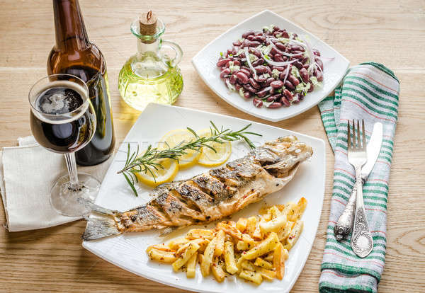 Baked seabass with fried potatoes Stock photo © Alex9500