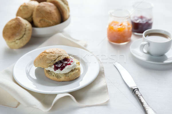 Scones with cream and fruit jam and cup of coffee Stock photo © Alex9500