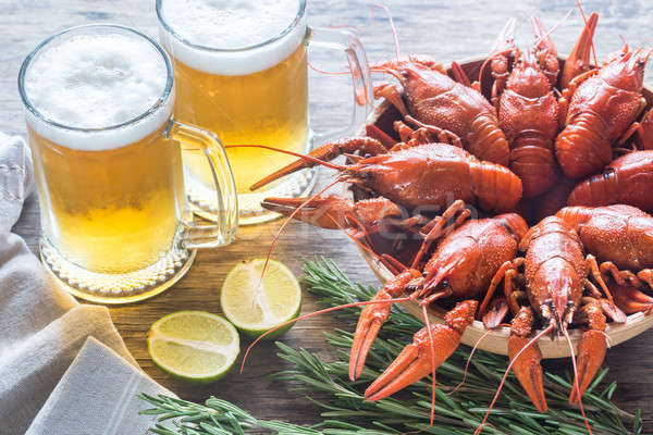 Stock photo: Bowl of boiled crayfish with two mugs of beer