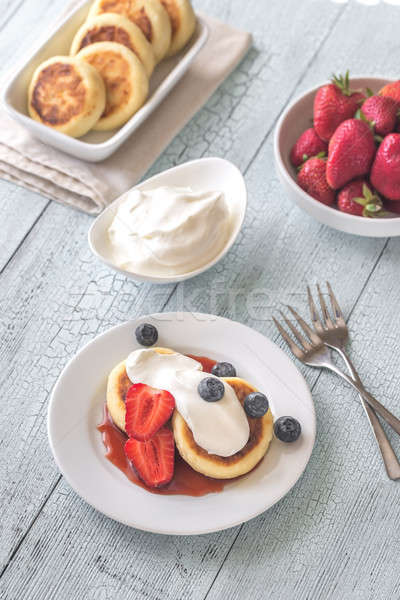 Stock photo: Cottage cheese patties with whipped cream