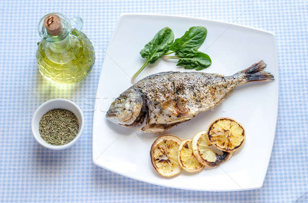 Grilled dorada fish with lemon and spinach Stock photo © Alex9500