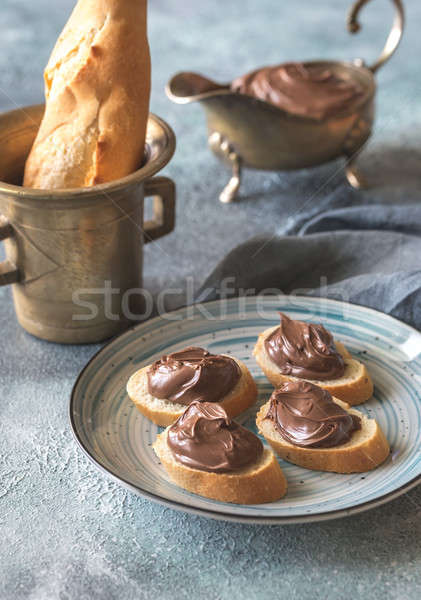 Slices of baguette with chocolate cream on the plate Stock photo © Alex9500