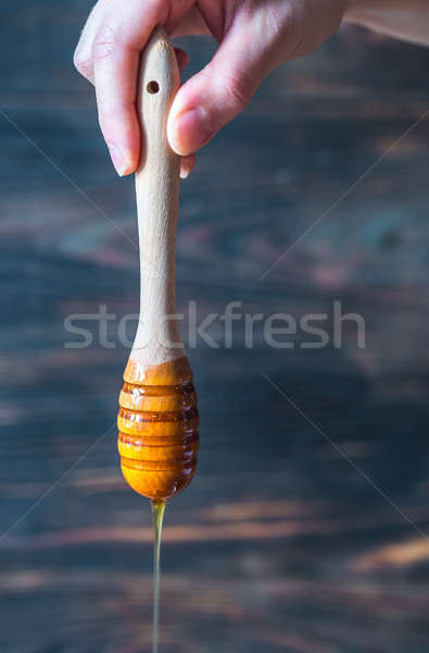 Pouring honey on the dark wooden background Stock photo © Alex9500