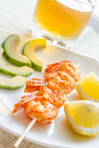 Shrimps skewers with avocado and lemon slices Stock photo © Alex9500