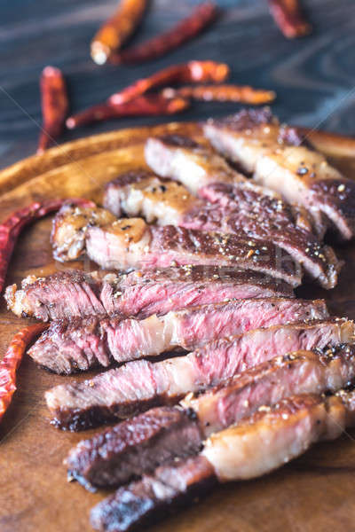 Cut beef steak on the wooden board Stock photo © Alex9500
