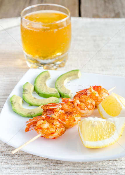 Shrimps skewers with avocado and lemon slices Stock photo © Alex9500