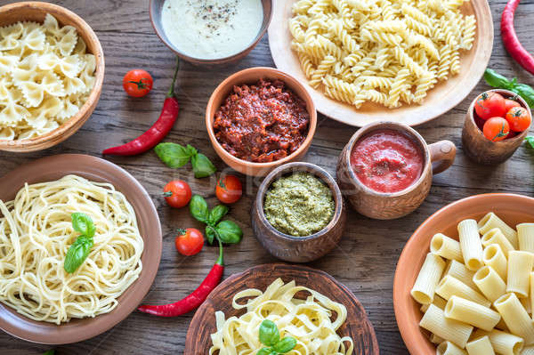 Stock photo: Pasta with different kinds of sauce on the wooden background